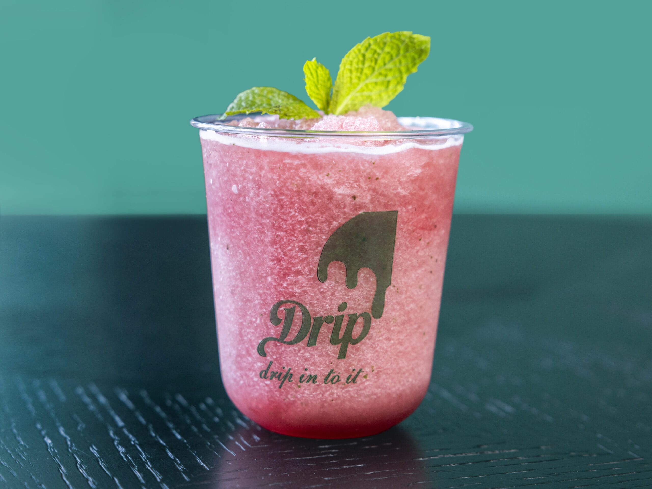 Drip Cafe Red Slush, a bright, frozen red beverage with a mint garnish, served in a branded Drip cup.