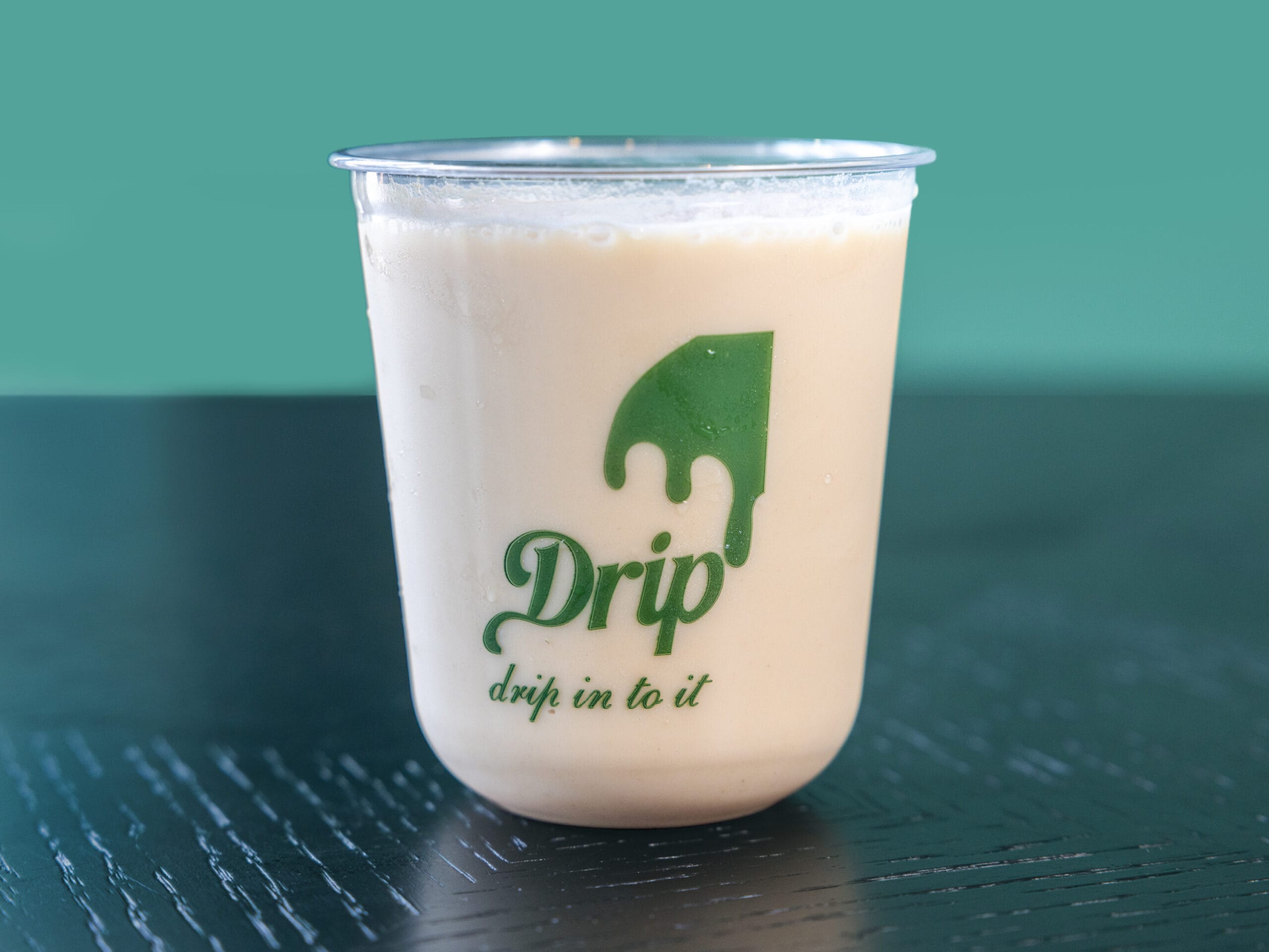 Drip Cafe Iced White Mocha Shaken espresso drink, featuring a light creamy coffee color and served over ice in a branded Drip cup.