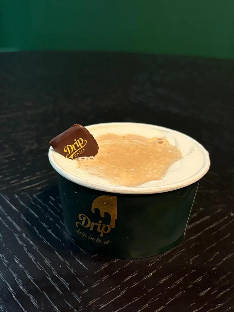 Drip Cafe Affogato, a classic Italian dessert with espresso poured over vanilla ice cream, served in a small branded cup and topped with a Drip Cafe chocolate piece