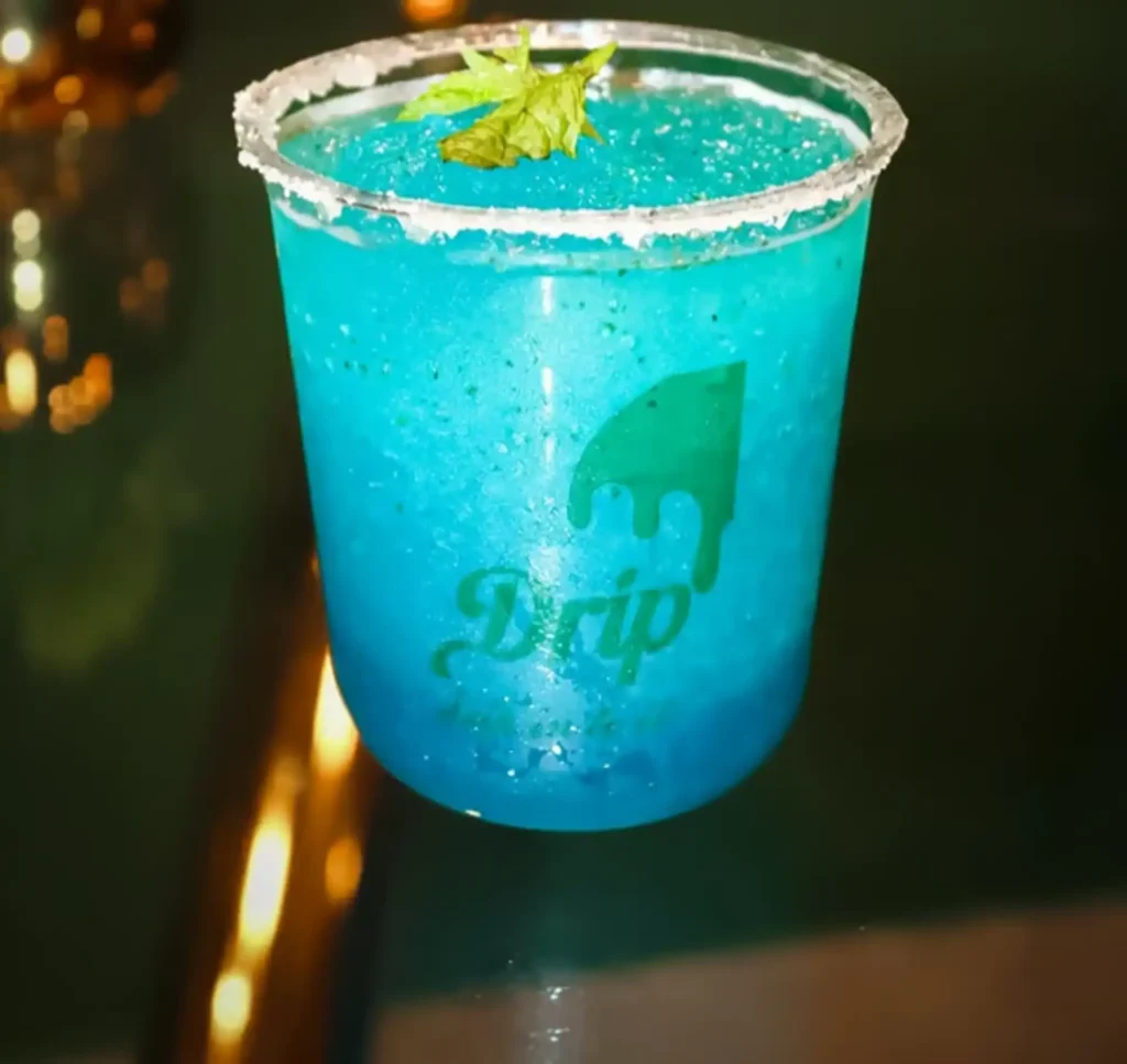 Drip Cafe Blue Slush frozen drink with sugar rim and mint garnish